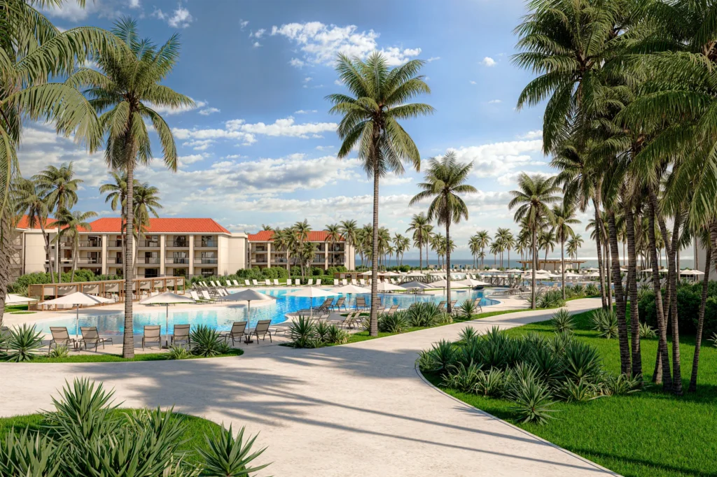 Scenic pool and garden pathways with resort buildings and palm trees at Hyatt Vivid Punta Cana.