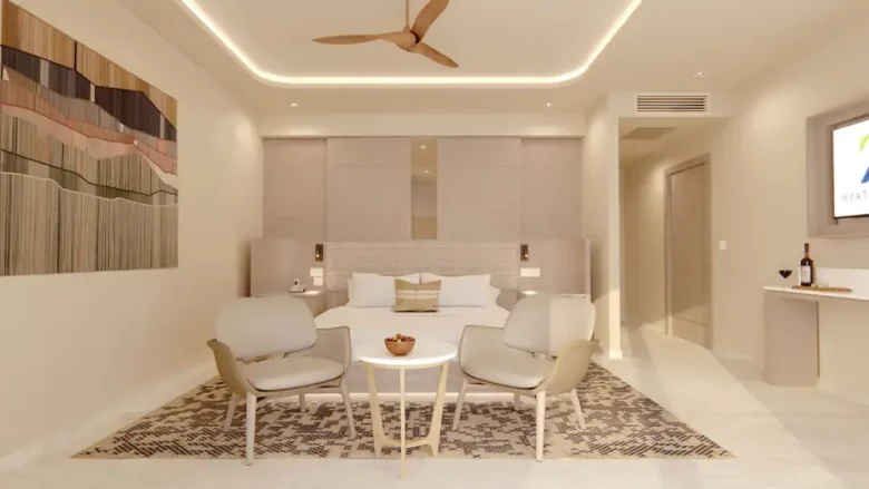 Presidential Suite bedroom with king bed, separate living area, and modern luxury furnishings at Hyatt Zilara Cancun.