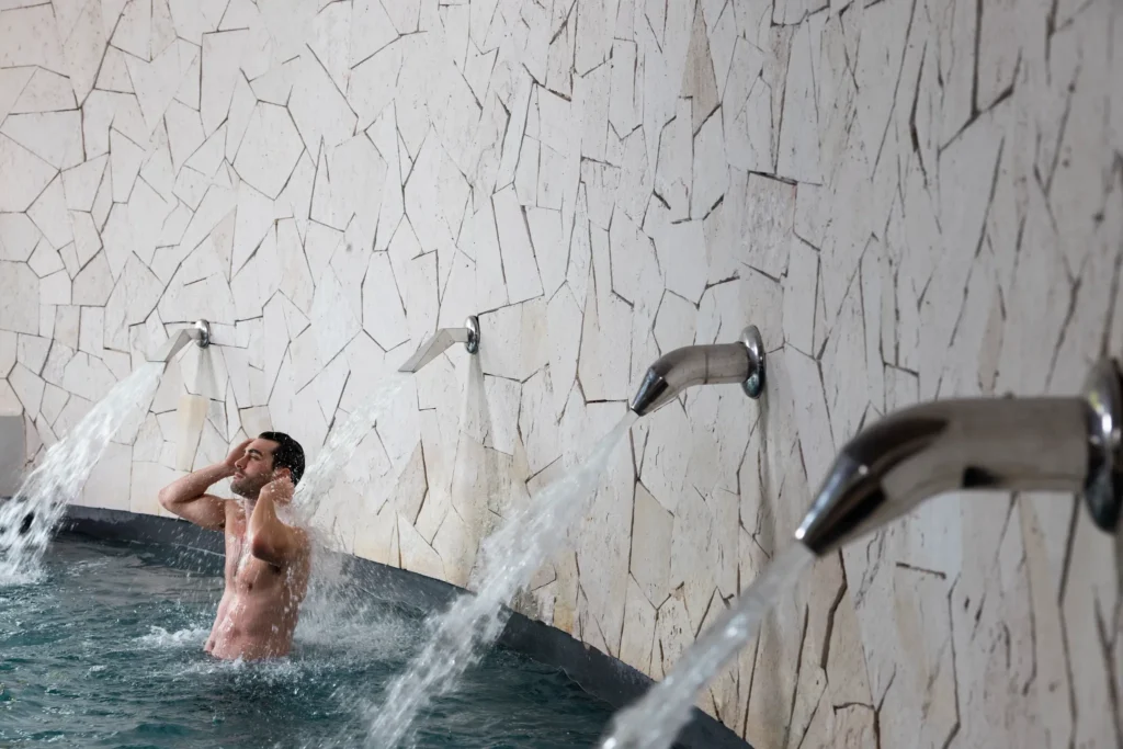 Guest enjoying hydrotherapy water features at Hyatt Zilara Riviera Maya spa, designed for relaxation and muscle recovery.