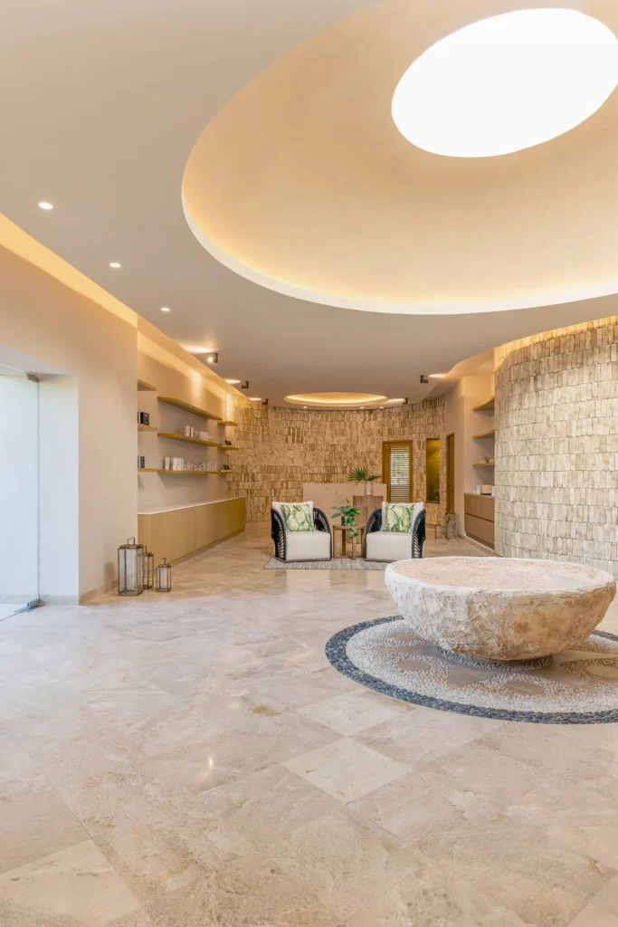 Modern spa lobby with natural stone decor and soft lighting at Hyatt Zilara Riviera Maya, creating a calming wellness environment.