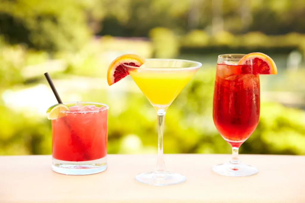 Lola Beach Club bar at Hyatt Zilara Riviera Maya featuring colorful tropical cocktails with citrus garnishes served in an oceanfront setting.