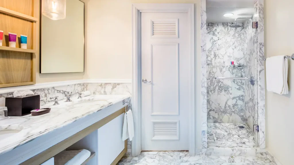 Swim-Up King bathroom with walk-in rain shower and marble finishes at Hyatt Zilara Rose Hall.