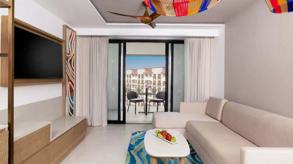 Club Deluxe Ocean View One Bedroom Master Suite living room with sleeper sofa and private balcony at Hyatt Ziva Los Cabos.