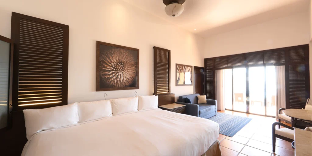King guest room with modern furnishings and private balcony at Hyatt Ziva Los Cabos.