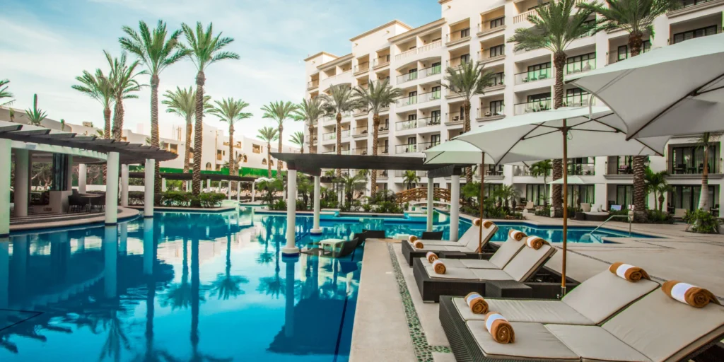 Main resort pool with luxury loungers and palm trees at Hyatt Ziva Los Cabos overlooking the Sea of Cortez.