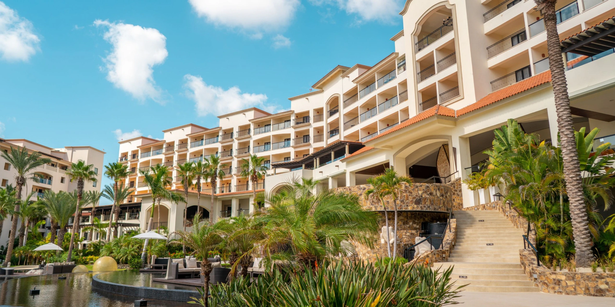 Exterior view of Hyatt Ziva Los Cabos showcasing elegant architecture, tropical landscaping, and luxury beachfront accommodations in San José del Cabo.