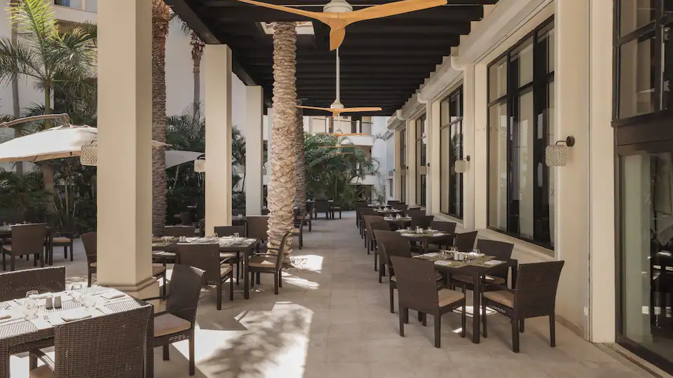 La Plaza international buffet restaurant at Hyatt Ziva Los Cabos featuring interactive cooking stations, fresh cuisine, and casual family-friendly dining.