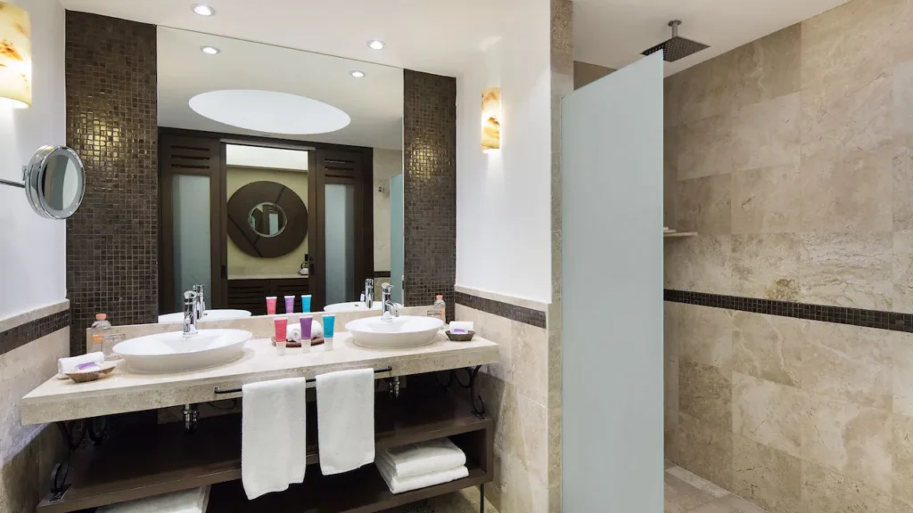 Oceanfront Double bathroom with double vanity and walk-in rain shower at Hyatt Ziva Los Cabos.