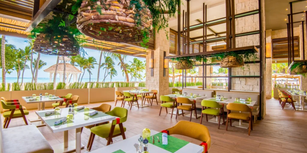 Open-air beachfront restaurant at Hyatt Ziva Cap Cana featuring modern Caribbean-inspired design, tropical décor, and ocean views in Punta Cana.