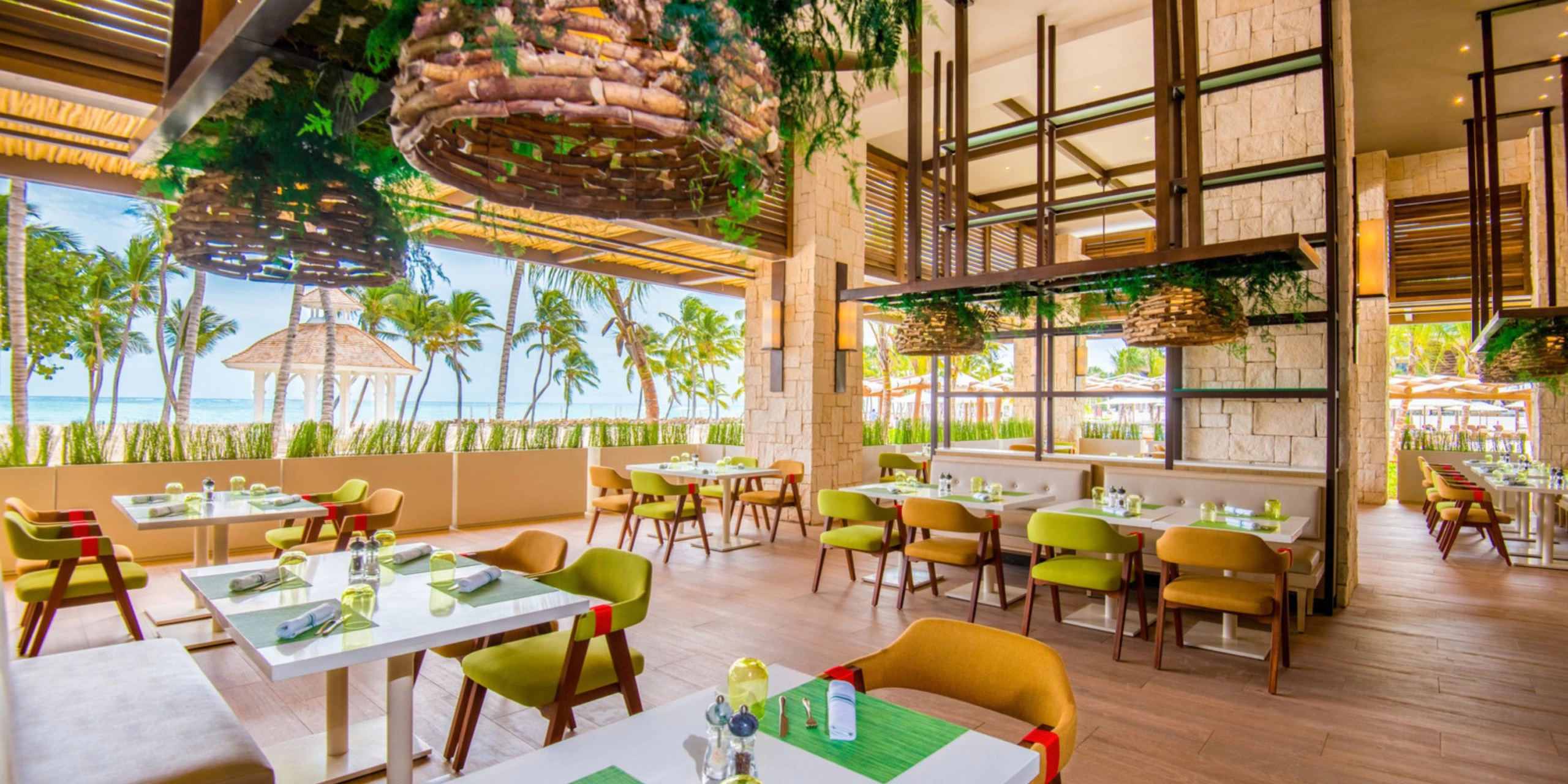 Open-air beachfront restaurant at Hyatt Ziva Cap Cana featuring modern Caribbean-inspired design, tropical décor, and ocean views in Punta Cana.
