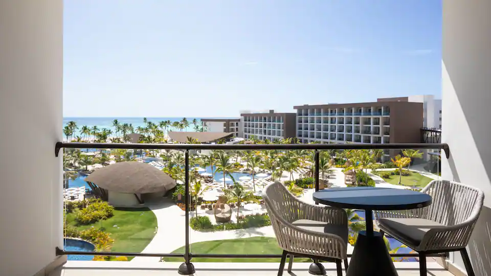 Ocean View Junior Suite King balcony seating area overlooking Hyatt Ziva Cap Cana and the Caribbean Sea.