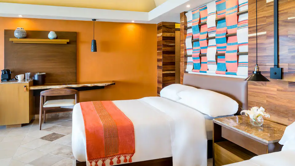 Club Ocean View Suite Double with two double beds and sitting area at Hyatt Ziva Puerto Vallarta.
