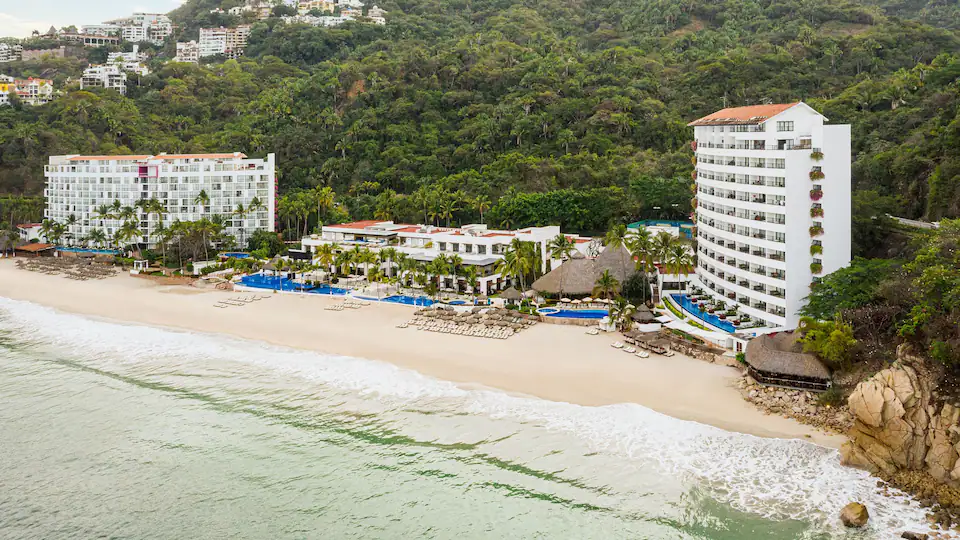 Aerial view of Hyatt Ziva Puerto Vallarta featuring beachfront towers, oceanfront pools, and a secluded sandy beach.