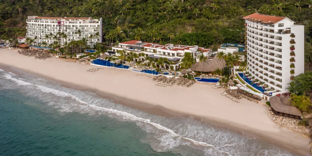 Aerial view of Hyatt Ziva Puerto Vallarta showcasing its private beach, oceanfront pools, and tropical surroundings.