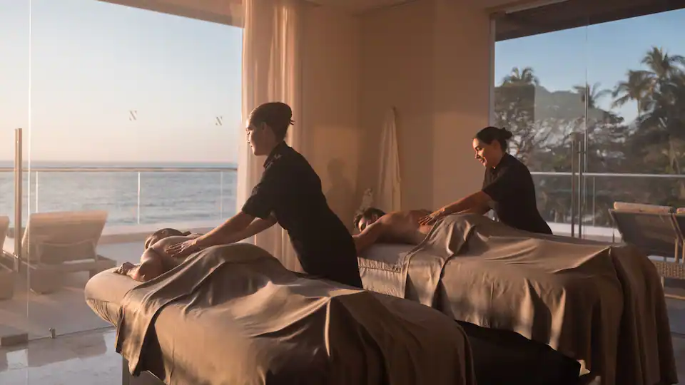 Couple enjoying a relaxing ocean-view massage at the spa at Hyatt Ziva Puerto Vallarta.
