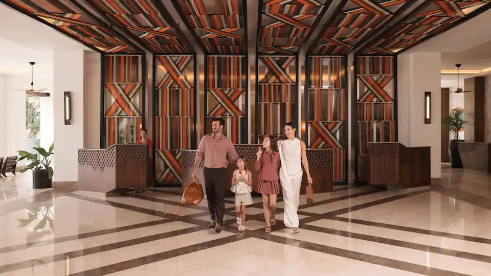 Family arriving through the welcoming lobby at Hyatt Ziva Puerto Vallarta for an all-inclusive vacation.