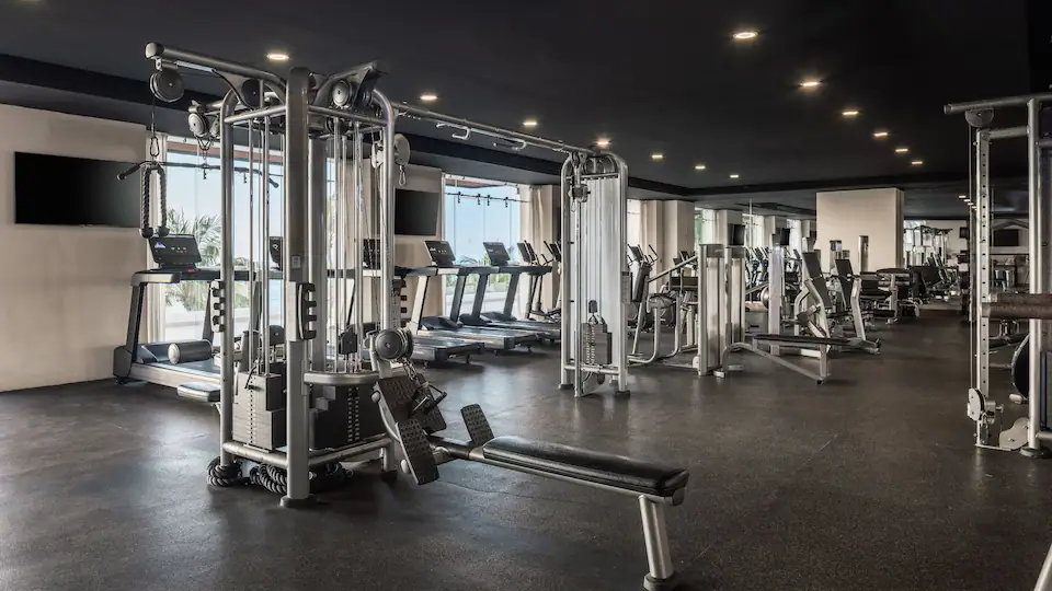 Modern fitness center at Hyatt Ziva Puerto Vallarta equipped with cardio machines, strength equipment, and ocean views.