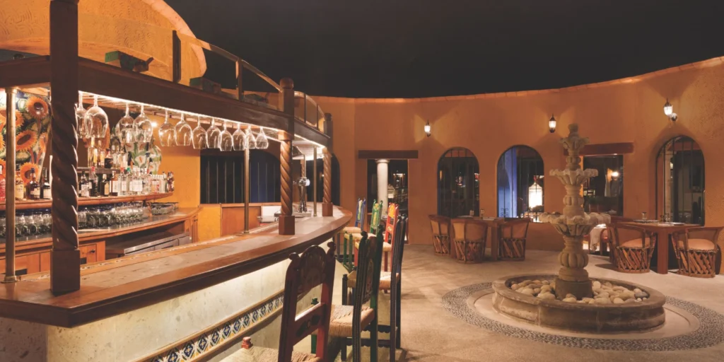 Elegant Mexican-inspired bar and lounge area at Hyatt Ziva Puerto Vallarta featuring traditional architecture and warm ambiance.