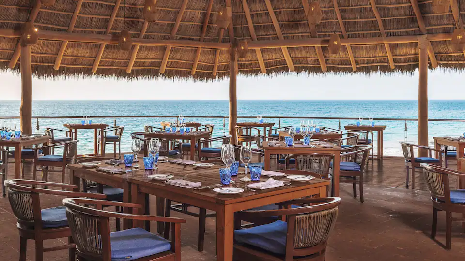 Open-air oceanfront restaurant at Hyatt Ziva Puerto Vallarta featuring panoramic Pacific Ocean views.