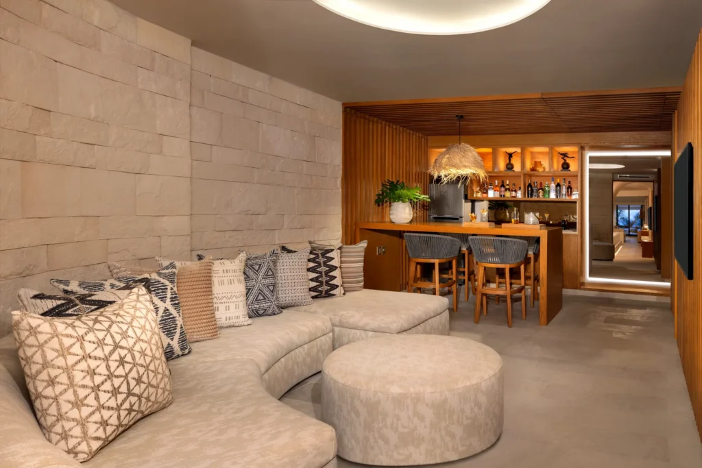 Separate living area with bar and seating in Paramount Suite Ocean Front at Impression Isla Mujeres by Secrets.
