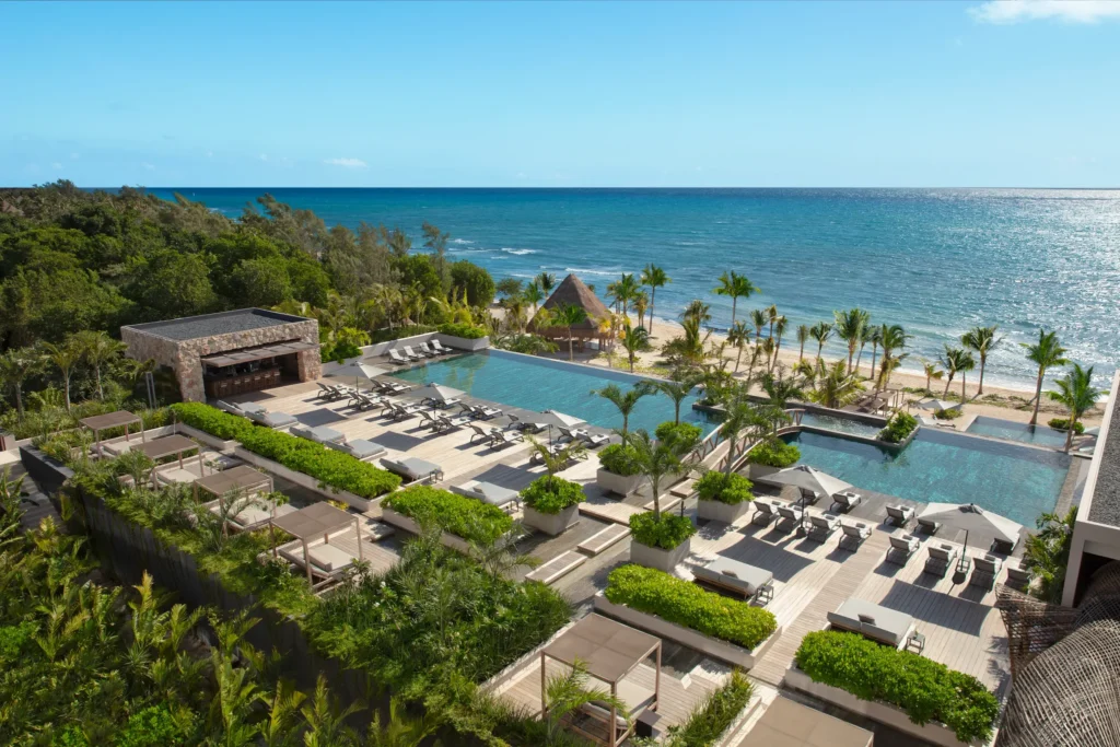 Impression Main Pool Bar at Impression Moxché by Secrets featuring rooftop infinity pools, ocean views, luxury loungers, and poolside service.