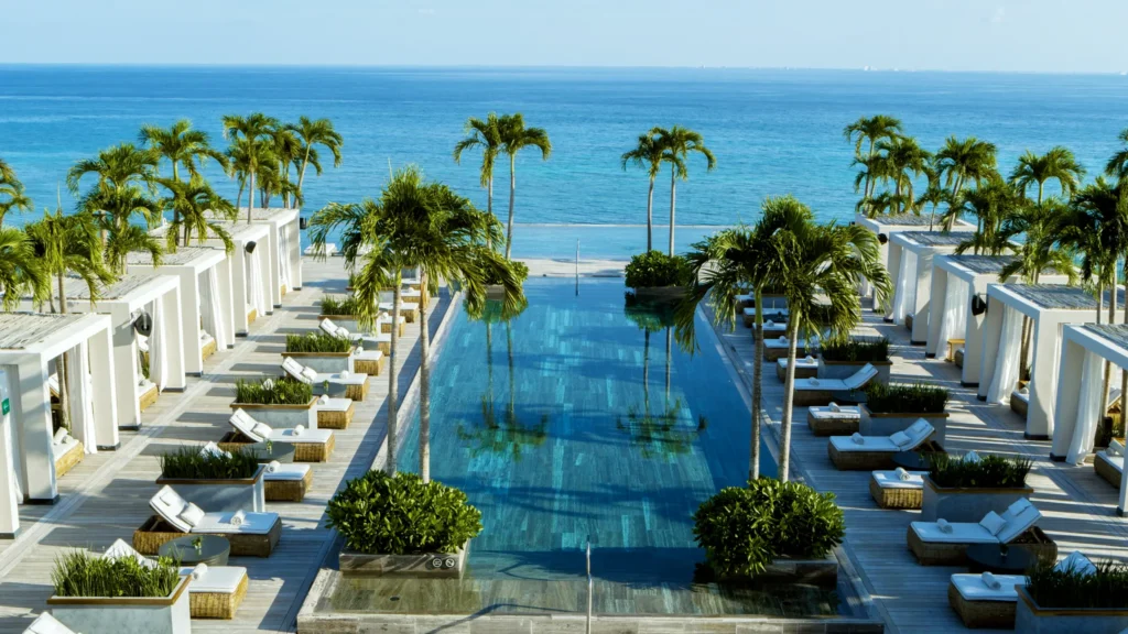 Aerial view of Cielo rooftop infinity pool overlooking the Caribbean Sea at Impression Moxché by Secrets.