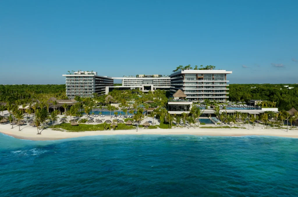 Oceanfront aerial view of Impression Moxché by Secrets resort along the white-sand beaches of Playa del Carmen.