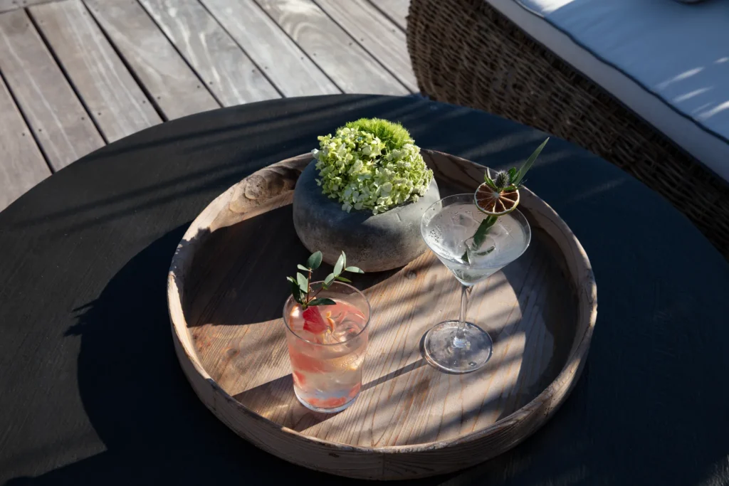 Elegant handcrafted cocktails served on a wooden tray at Impression Moxché by Secrets in Playa del Carmen.
