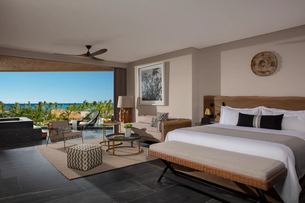 Signature Suite Tropical View with king bed, private terrace soaking tub, and lush garden views at Impression Moxché by Secrets.