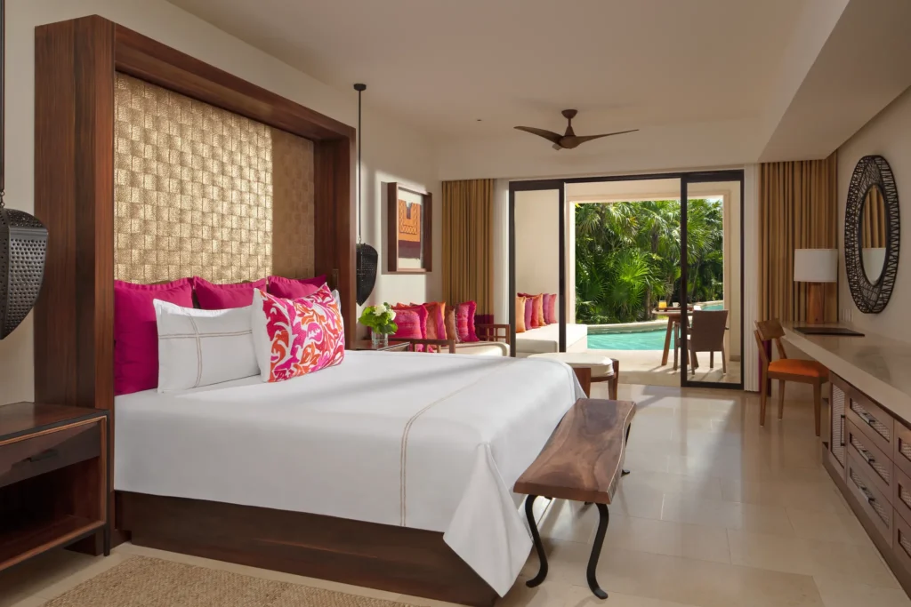 Junior Suite Ocean View with king bed and sitting area at Secrets Akumal Riviera Maya with balcony access.
