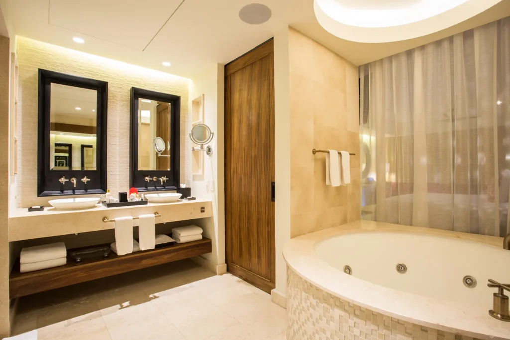 Junior Suite Partial Ocean View bathroom with double sinks and in-room hot tub at Secrets Akumal Riviera Maya.