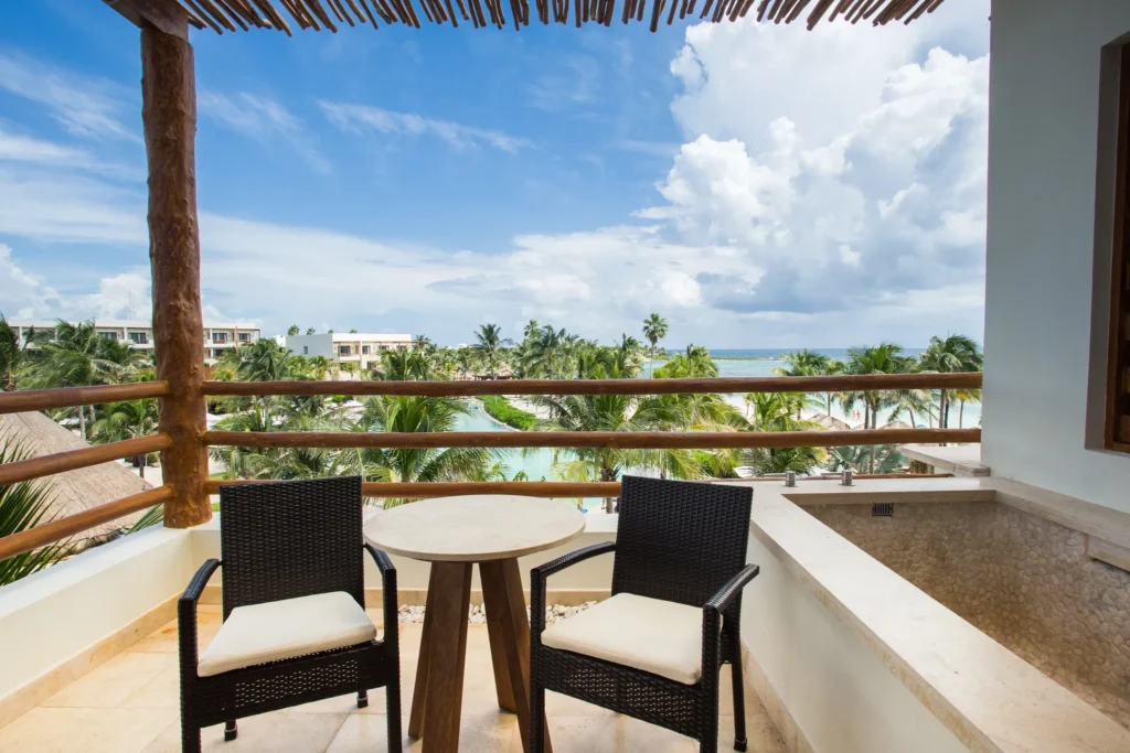 Preferred Club Junior Suite Ocean Front balcony with outdoor seating and private plunge pool at Secrets Akumal Riviera Maya.