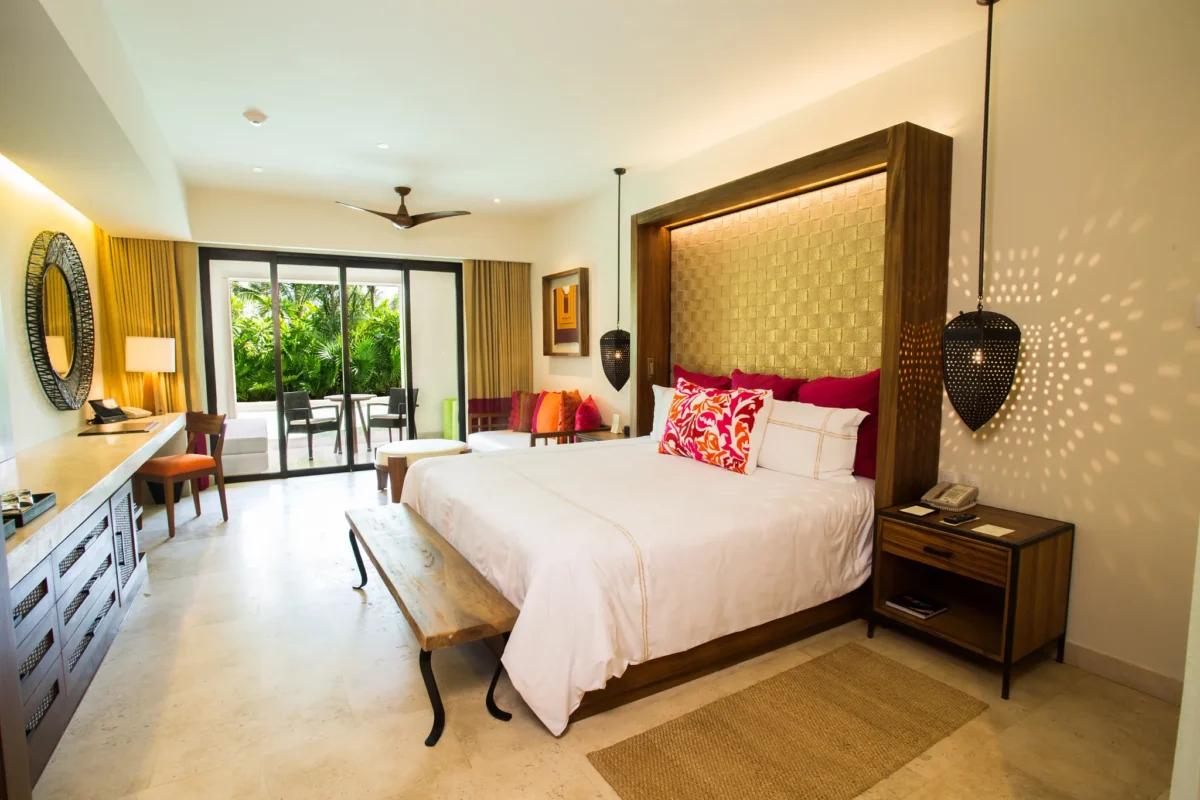 Preferred Club Junior Suite Swim Out with king bed and seating area at Secrets Akumal Riviera Maya.