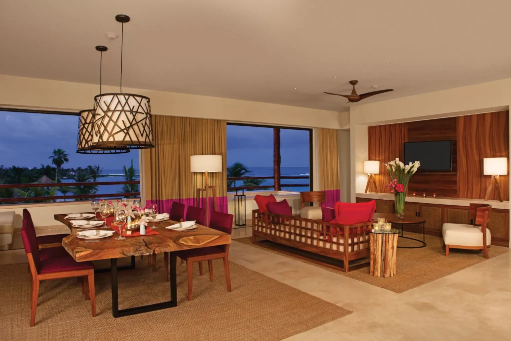 Presidential Suite living room and dining area with ocean views at Secrets Akumal Riviera Maya.