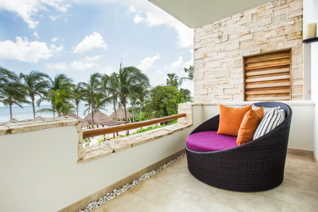 Romance Master Suite Ocean Front balcony lounge chair with ocean view at Secrets Akumal Riviera Maya.