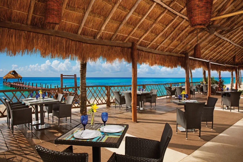 Oceana seafood restaurant at Secrets Aura Cozumel featuring oceanfront outdoor dining, fresh seafood dishes, and Caribbean views.
