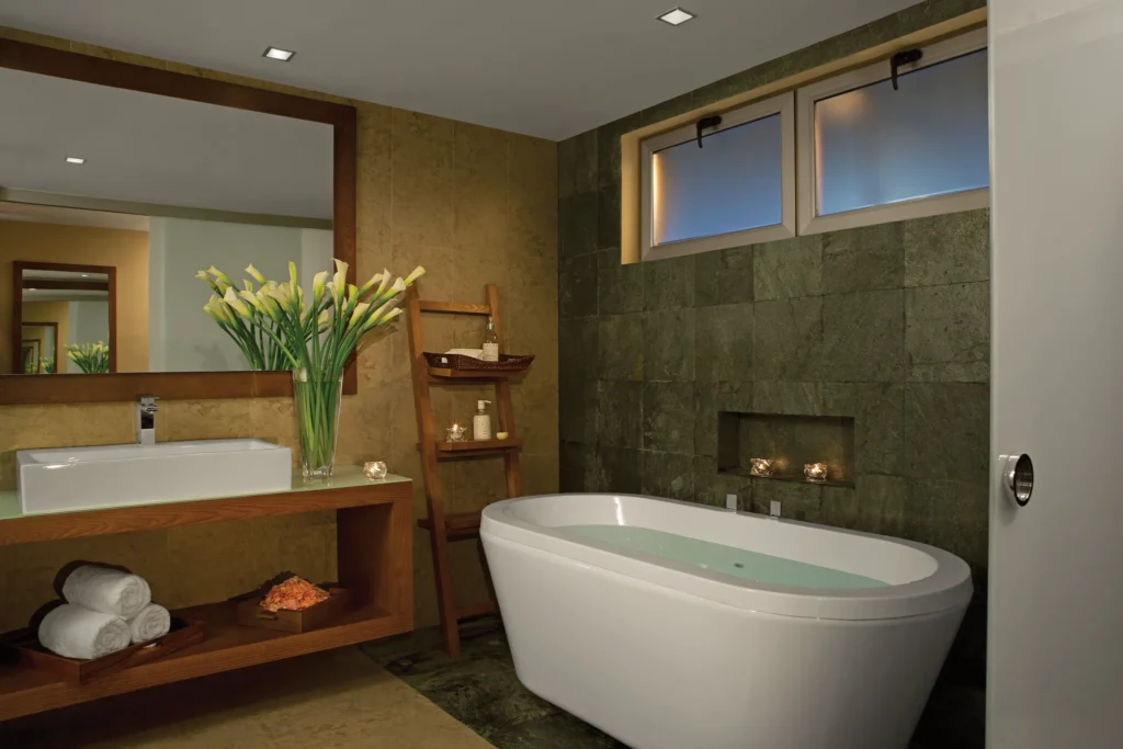 Preferred Club Junior Suite Ocean View bathroom with soaking tub and modern vanity at Secrets Aura Cozumel.