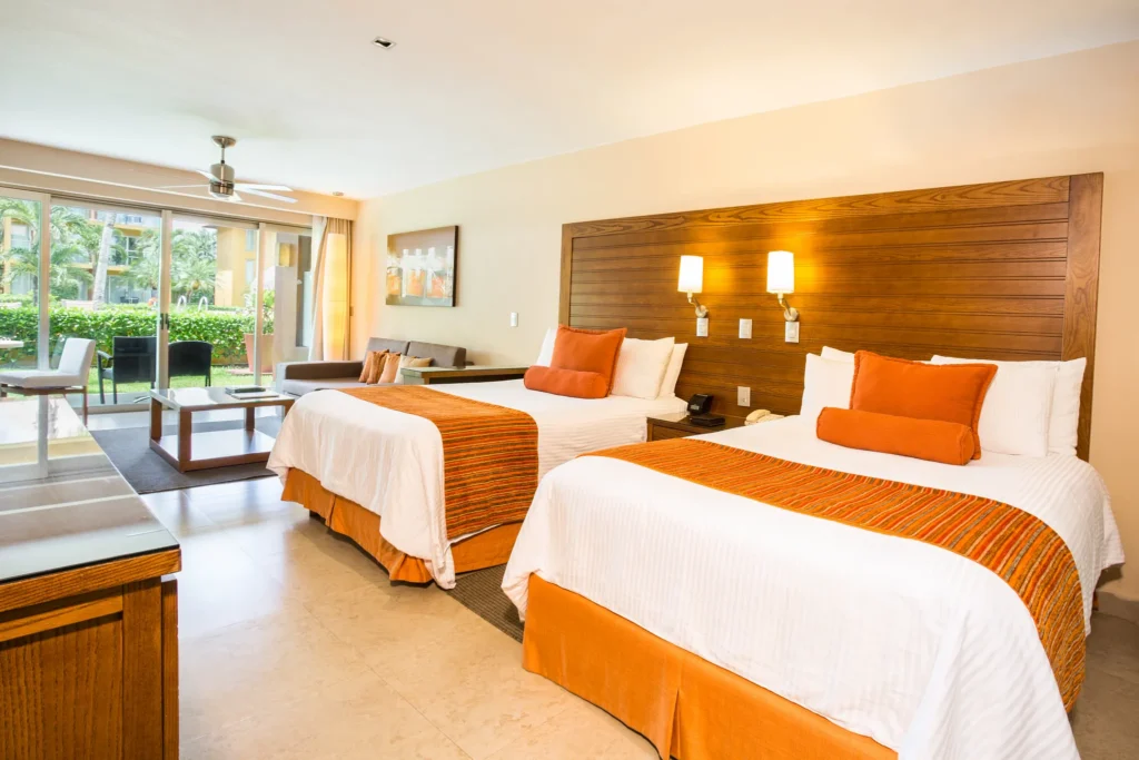 Preferred Club Junior Suite with two queen beds and pool view at Secrets Aura Cozumel.