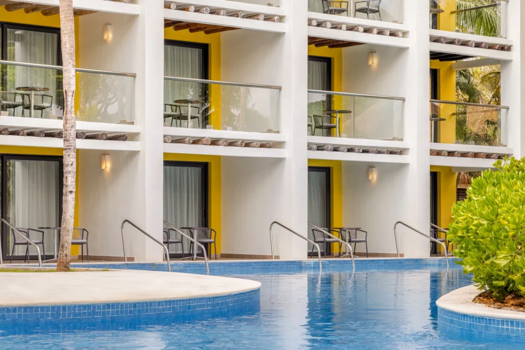 Swim-up Preferred Club Junior Suite balconies with direct pool access at Secrets Aura Cozumel.