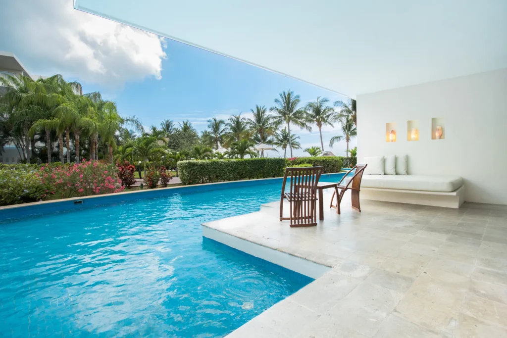 Preferred Club Junior Suite Swim-Up Ocean View terrace with private pool and lounge seating at Secrets Aura Cozumel.