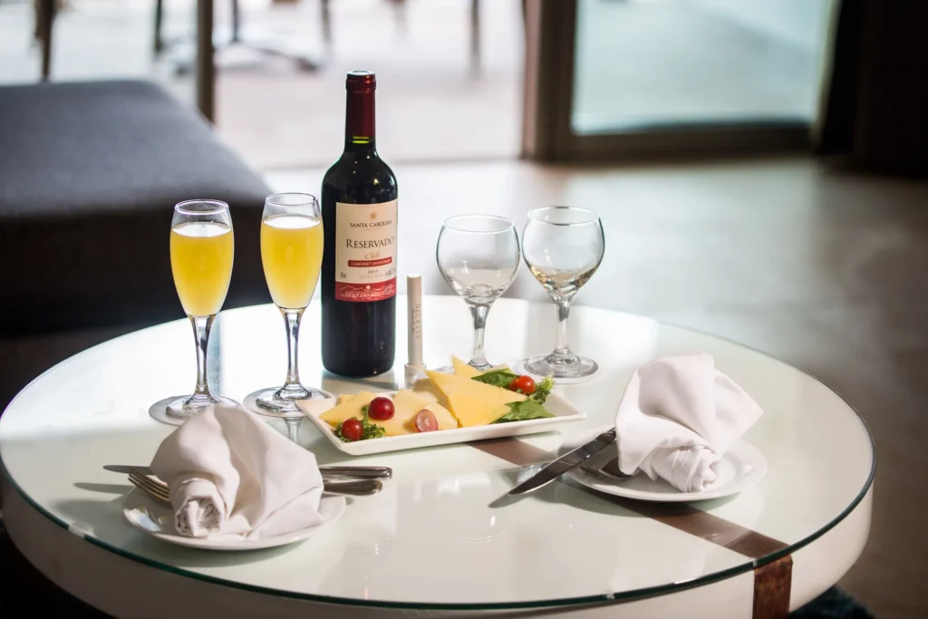 Preferred Club Superior Junior Suite Ocean View in-room dining setup with wine and appetizers at Secrets Aura Cozumel.
