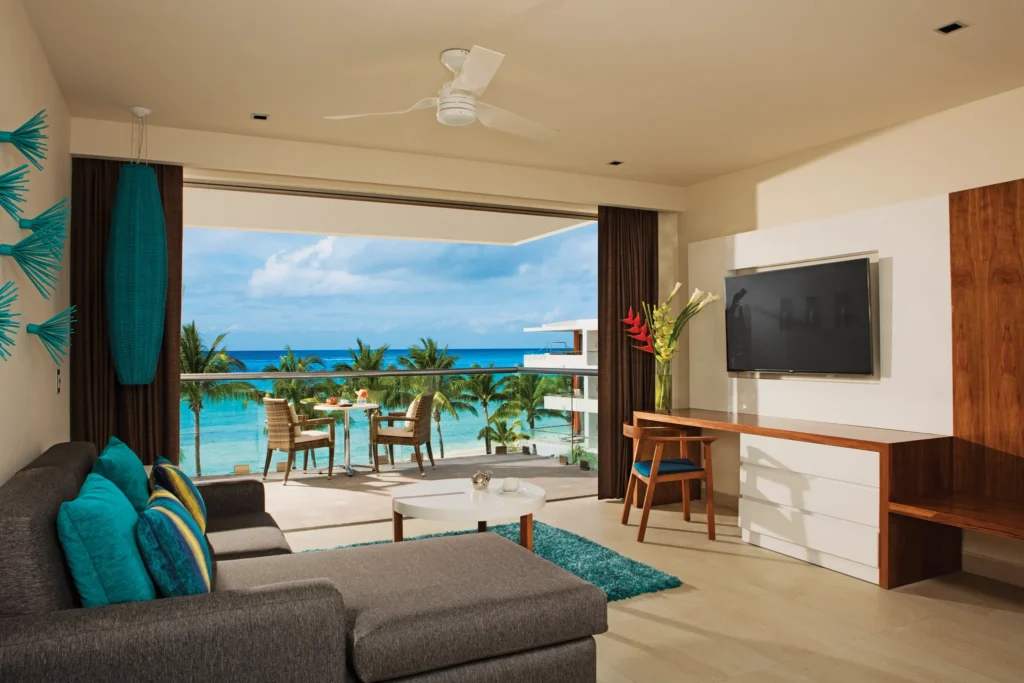 Preferred Club Superior Junior Suite Ocean View living area with terrace access and ocean views at Secrets Aura Cozumel.