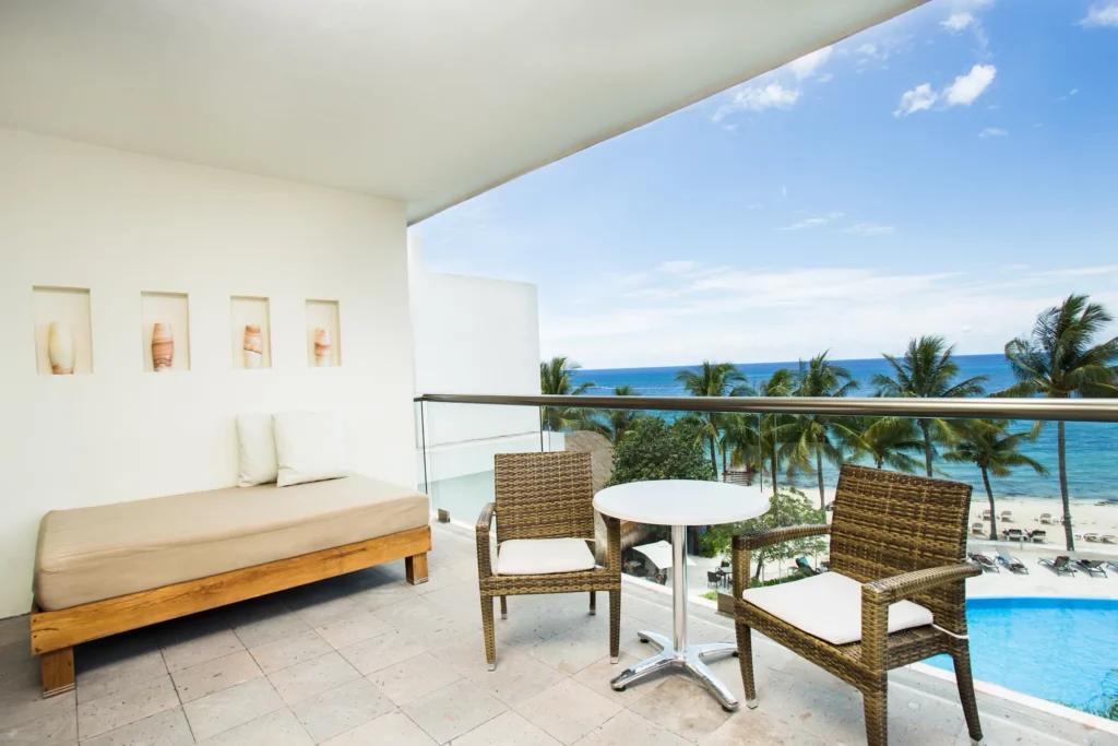 Preferred Club Superior Junior Suite Ocean View terrace with seating and panoramic ocean views at Secrets Aura Cozumel.
