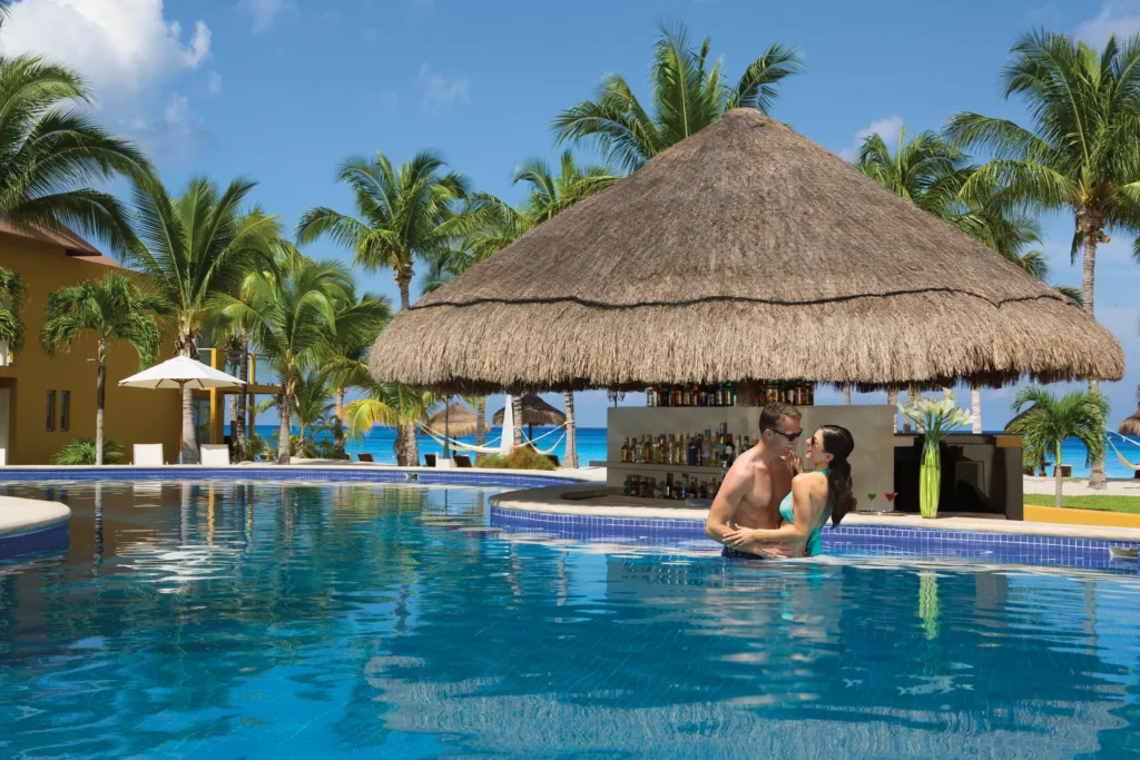 Preferred Club Swim-Up Bar at Secrets Aura Cozumel featuring a private poolside bar, refreshing cocktails, and relaxed beach-casual atmosphere.