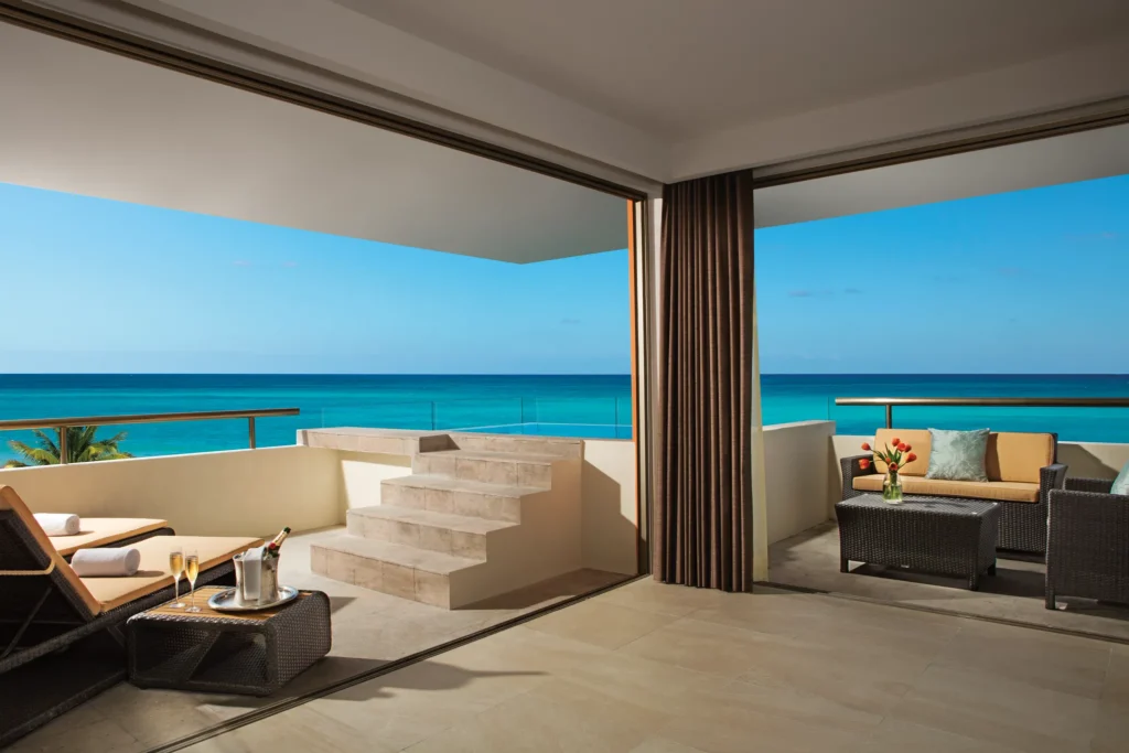 Oceanfront rooftop terrace with plunge pool and lounge chairs at Secrets Aura Cozumel suite.