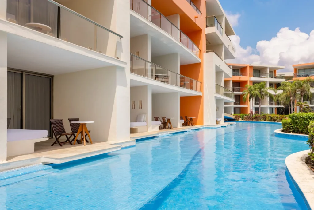 Swim-up pool outside Junior Suites at Secrets Aura Cozumel with modern resort architecture.