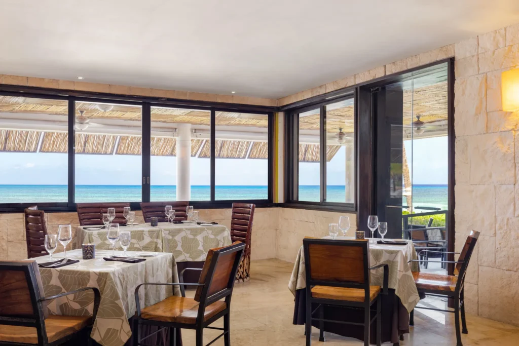 Windows Restaurant at Secrets Aura Cozumel featuring elegant dining, international cuisine, and an extensive fine wine cellar selection.