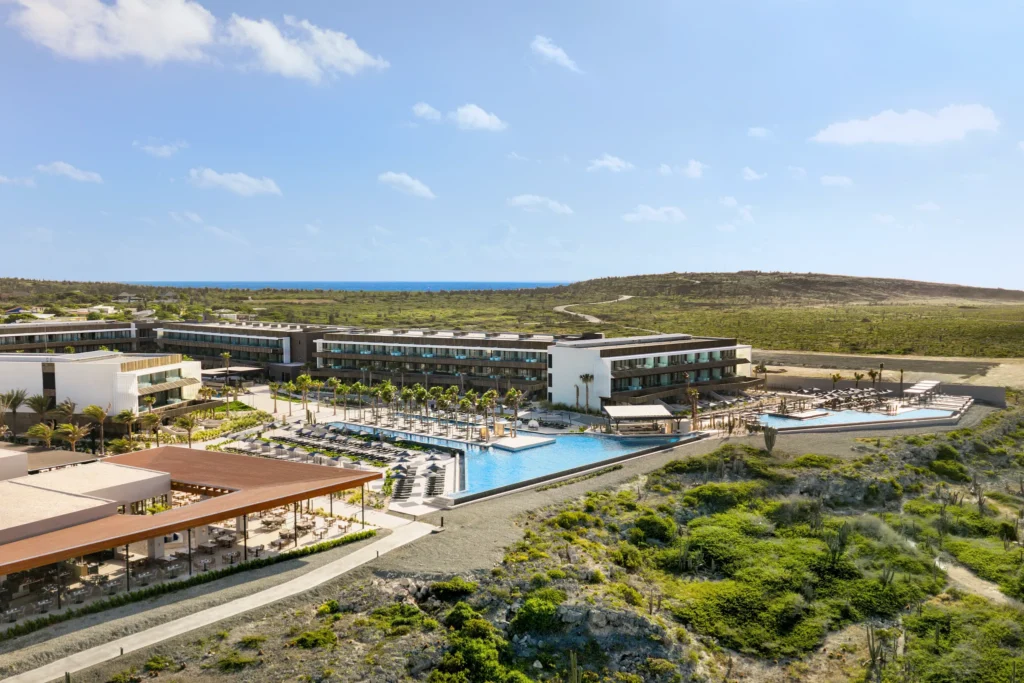 Panoramic aerial view of Secrets Baby Beach Aruba overlooking the Caribbean Sea.