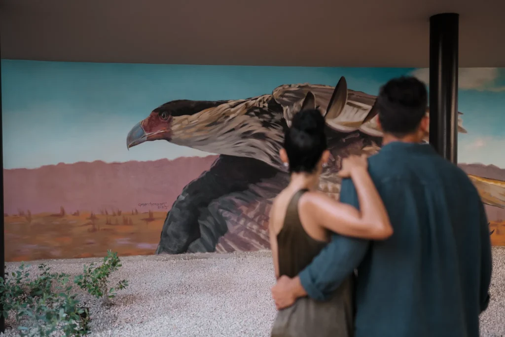 Couple admiring local-inspired artwork at Secrets Baby Beach