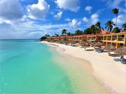 Divi Aruba All Inclusive beachfront resort with palm trees, pools, and white sand beach on Druif Beach in Aruba.